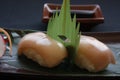 Nigiri sushi with shrimp and tuna fish on a gourmet platting on black background.