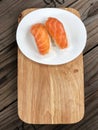 Nigiri Sushi in white dish on the wooden tray and wooden background with natural light. Royalty Free Stock Photo