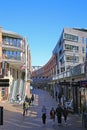 View on pedestrian shopping street with people on sunny winter day