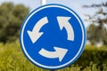 NIJVERDAL, NETHERLANDS - Aug 02, 2020: Roundabout sign with out of focus blurred street background