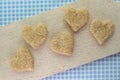 Oatmeal and coconut flakes heart cookies on cutting board Royalty Free Stock Photo