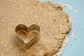 Heart-shaped cookie cutter on raw organic dough Royalty Free Stock Photo