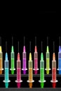 Vaccines syringes of different colors on black background Royalty Free Stock Photo