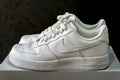 Nike Air Force 1 white sneakers isolated on dark background. Illustrative editorial photo. Royalty Free Stock Photo