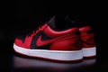 Nike Air Jordan 1 Retro Low Reverse Bred colorway sneakers on black background illustrative editorial Royalty Free Stock Photo