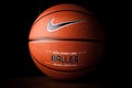 Nike brand, basketball ball Nike Baller. Orange rubber outdoor ball, ultra-durable cover, close-up on a black background