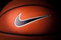 Nike brand, basketball ball Nike Baller. Orange rubber outdoor ball, ultra-durable cover, close-up on a black background