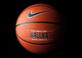 Nike brand, basketball ball Nike Baller. Orange rubber outdoor ball, ultra-durable cover, close-up on a black background