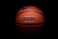 Nike brand, basketball ball Nike Baller. Orange rubber outdoor ball, ultra-durable cover, close-up on a black background