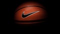 Nike brand, basketball ball Nike Baller. Orange rubber outdoor ball, ultra-durable cover, close-up on a black background