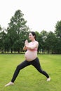 Asian Eastern Chinese young pretty pregnant girl woman do yoga sit in meditation, do lotus gesture of yoga over sunset,namaste Royalty Free Stock Photo