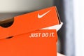 Nike running shoes box with Just Do It and nike logo on orange box in the store