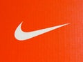 Nike white logo on cardboard orange sneakers box.