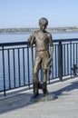 Nikolaev, Ukraine - September 20, 2020: bronze statue of a boy with a goby fish and a cat