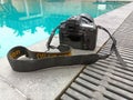 Nikon D750 camera. A swimming pool in the background.