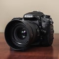 Nikon dslr camera on wooden table, close up