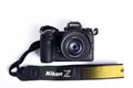 Nikon Z6 I camera photograph confrontation and competition between cameras. White background. The best mirrorless