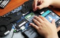 NIKOPOL, UKRAINE - JUNE, 2018: The technician hold the screwdriver for repairing the computer, the concept of computer hardware,