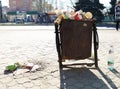 Nikopol, Ukraine, May 20, 2019: a crowded trash can on the Ukrainian street, with garbage on paving slabs Royalty Free Stock Photo