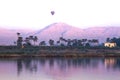 Nile river at sunrise with hot air balloons in Luxor, Egypt. Royalty Free Stock Photo