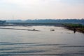 Nile river with the banks full of trees and vegetation and Egyptian fishermen in their typical rowing boats in the center of the r