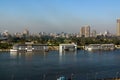 Nile River on its way through the city of Cairo Egypt with boats moored on the shore and view of modern buildings Royalty Free Stock Photo