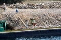 Egyptian workers load stones by hand on a barge on the Nile River