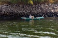 Nile river, near Aswan, February 16, 2017: fisherman paddling in a small boat in the dio, dressed in the typical Egyptian white an Royalty Free Stock Photo