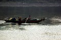 Nile River, near Aswnm, Egypt, February 21, 2017: Egyptian fisherman transporting two people in their boat in the middle of the Ni Royalty Free Stock Photo