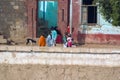 Nile River, near Aswnm, Egypt, February 21, 2017: Egyptian wives and children from a small village on the bank of the Nile River, Royalty Free Stock Photo