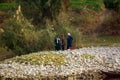 Nile River, near Aswnm, Egypt, February 21, 2017: Three Egyptian fishermen dressed in djellaba and turban on the banks of the Nile Royalty Free Stock Photo