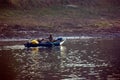 Nile River, near Aswnm, Egypt, February 21, 2017: Two Egyptian fishermen returning to the shore after their fishing with one paddl