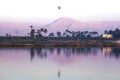 Nile river at sunrise with hot air balloons in Luxor, Egypt. Royalty Free Stock Photo