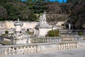 Nimes, Occitanie, France - Arched bridge at the water of the fountain gardens in old town