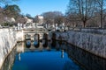 Nimes, Occitanie, France - Arched bridge at the water of the fountain gardens in old town Royalty Free Stock Photo