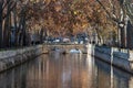 Nimes, Occitanie, France - Autumn trees reflecting in the canal of the Fountain gardens Royalty Free Stock Photo