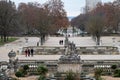 Nimes, Occitanie, France - The Fountain Gardens with trees and sculptures with pedestrians walking around