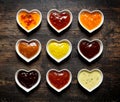 Nine colorful sauces and marinades in heart shaped bowls