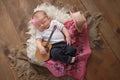 Newborn Baby Cowgirl Playing a Tiny Guitar Royalty Free Stock Photo