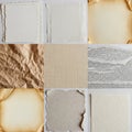 Nine different textured paper samples arranged in a grid. Papers include plain white Royalty Free Stock Photo