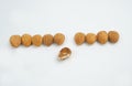 Nine Good almonds nut in a line and one bad almond on white background Royalty Free Stock Photo