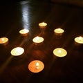 Nine lighted candles in dark room Royalty Free Stock Photo