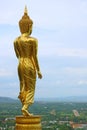 Nine metres high golden Buddha image in walking posture of Wat Phra That Khao Noi, a hilltop historic temple in Nan Province, Thai Royalty Free Stock Photo