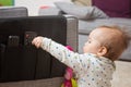 Nine months old baby girl grabbing remote control Royalty Free Stock Photo