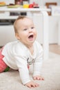 Nine months old baby girl playing crawling on the floor Royalty Free Stock Photo