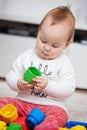 Nine months old baby girl playing with her toys Royalty Free Stock Photo