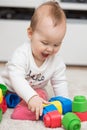 Nine months old baby girl sitting on the floor Royalty Free Stock Photo