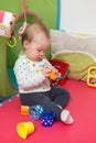 Nine months old baby girl sitting on the floor Royalty Free Stock Photo