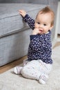 Nine months old baby girl sitting on the floor Royalty Free Stock Photo