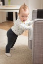 Nine months old baby girl standing on her feet Royalty Free Stock Photo